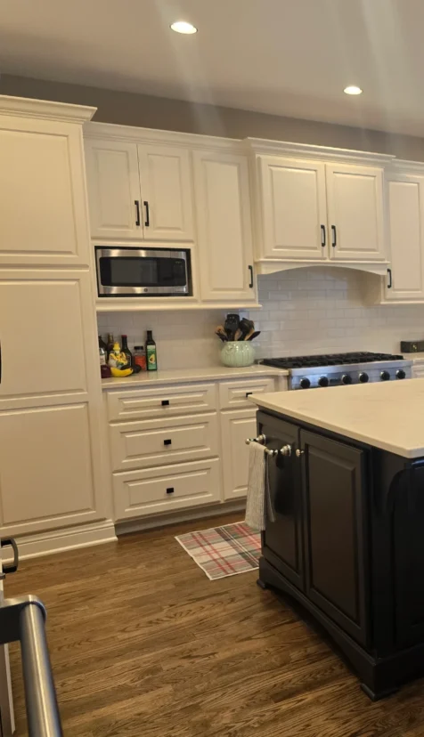 Pearly white kitchen with black accents, freshly deep cleaned.