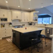 Pearly white kitchen with black accents, freshly deep cleaned.