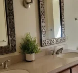Clean and tidy bathroom counter with two sinks.