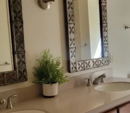 Clean and tidy bathroom counter with two sinks.