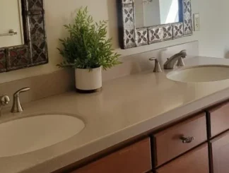 bathroom-beige-countertop-routine-cleaned Clean and tidy bathroom counter with two sinks.