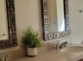 Clean and tidy bathroom counter with two sinks.