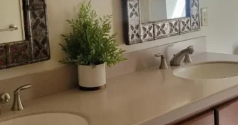 Clean and tidy bathroom counter with two sinks.