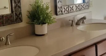 Clean and tidy bathroom counter with two sinks.