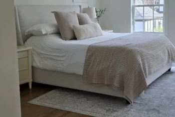 beautiful-tidy-bedroom A recently made bed in a white and beige bedroom.
