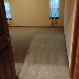 Clean vacuum lines in an empty beige bedroom after a move out clean.
