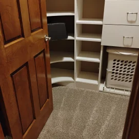 Clean closet after a move out deep clean with visible vacuum lines and empty shelves.