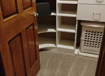 Clean closet after a move out deep clean with visible vacuum lines and empty shelves.