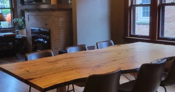 Unique wooden table in the middle of a small dining room.