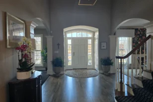 Tidy and clean entrance to a large home with a white door after a routine clean.