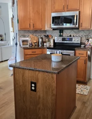 clean-kitchen-after-standard-cleaning Tidy black granite counters in a recently cleaned kitchen.