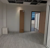 Freshly vacuumed empty office with a few boxes after move-in cleaning.