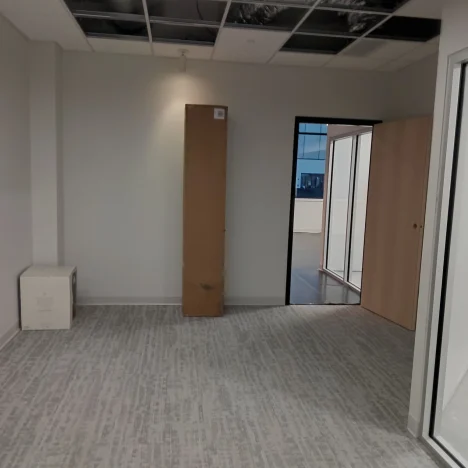 Freshly vacuumed empty office with a few boxes after move-in cleaning.