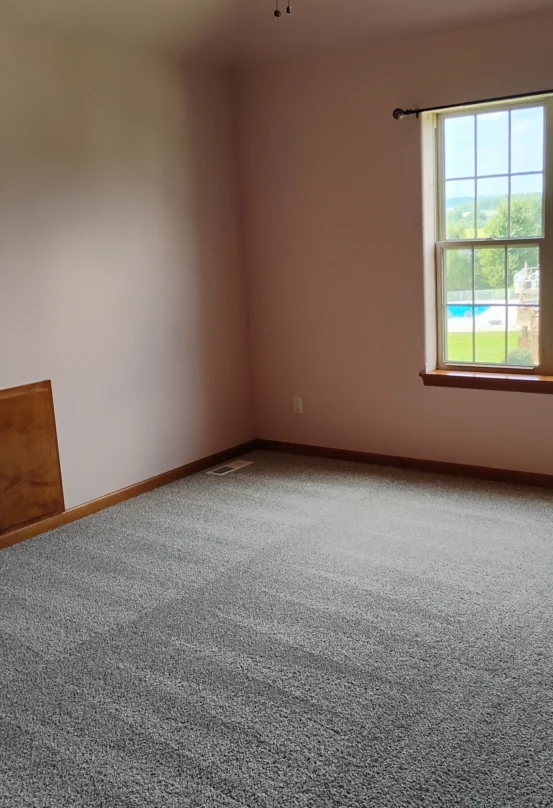 Freshly vacuumed gray carpet in the bedroom of a second floor of a home.