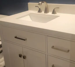 Clean modern porcelain bathroom counter and sink after a deep clean.