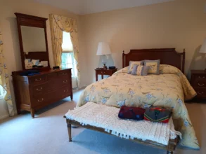 Tidy and clean bedroom with a freshly vacuumed carpet after a routine clean.