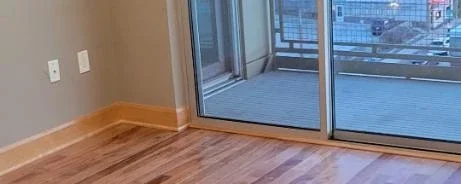 Deep cleaned empty living room in an apartment downtown Milwaukee with a scenic view.