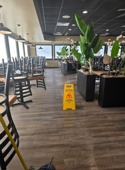 Dining room after mopping for a routine restaurant cleaning.
