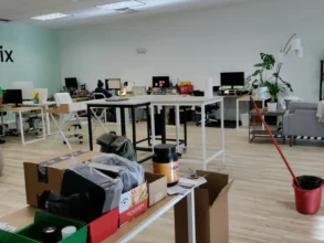 Open office with many desks after a routine clean mopping.