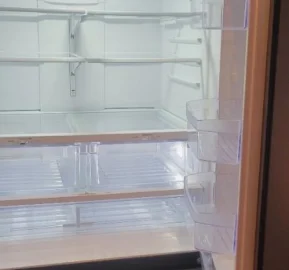 Freshly deep cleaned fridge with empty shelves.