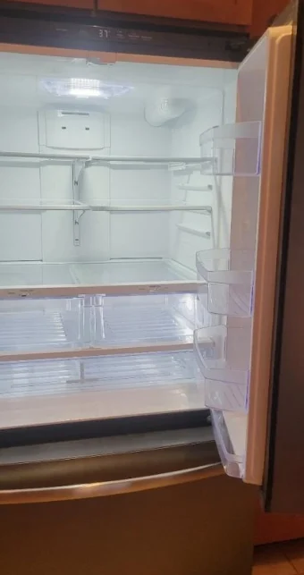 Freshly deep cleaned fridge with empty shelves.