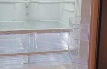 Freshly deep cleaned fridge with empty shelves.
