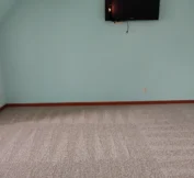 Light blue bedroom with a freshly vacuumed gray carpet after move-out deep clean.
