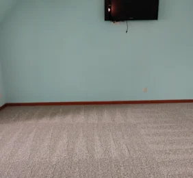 Light blue bedroom with a freshly vacuumed gray carpet after move-out deep clean.