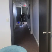 MG team member vacuuming office hallway during a routine clean.