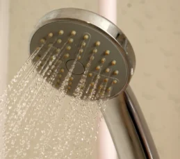 rinse-tub-and-shower Shower head spraying water to rinse tub for a move out deep clean.