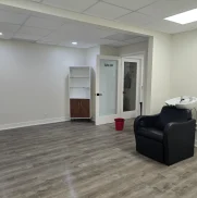 Salon studio after a move-out deep clean with a shiny gray wooden floor.