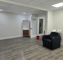Salon studio after a move-out deep clean with a shiny gray wooden floor.