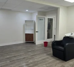 Salon studio after a move-out deep clean with a shiny gray wooden floor.