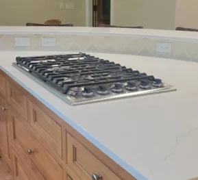 Clean granite countertop with a gas stove top after a routine clean.