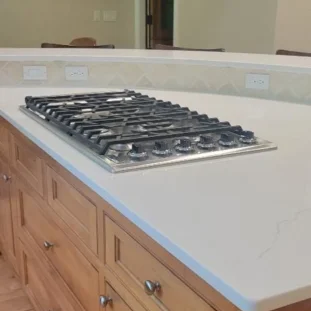 Clean granite countertop with a gas stove top after a routine clean.