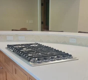 sparkling-countertop-stove Clean granite countertop with a gas stove top after a routine clean.
