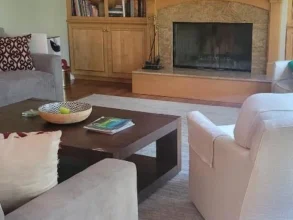 Clean living room after a routine with a brown brick fire place.