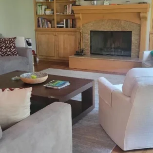 Clean living room after a routine with a brown brick fire place.