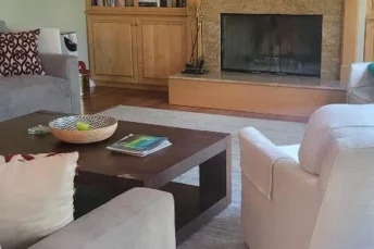 Clean living room after a routine with a brown brick fire place.