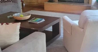 Clean living room after a routine with a brown brick fire place.