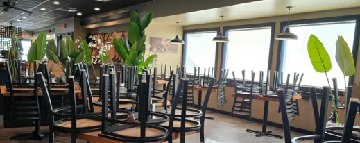 Clean restaurant dining room floor with chairs on tables after routine clean.