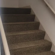 Clean stairs in a medium sized commercial building after routine vacuum.
