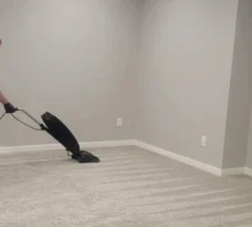 vacuuming-in-progress-focused Zoom into MG's manager vacuuming gray carpet.